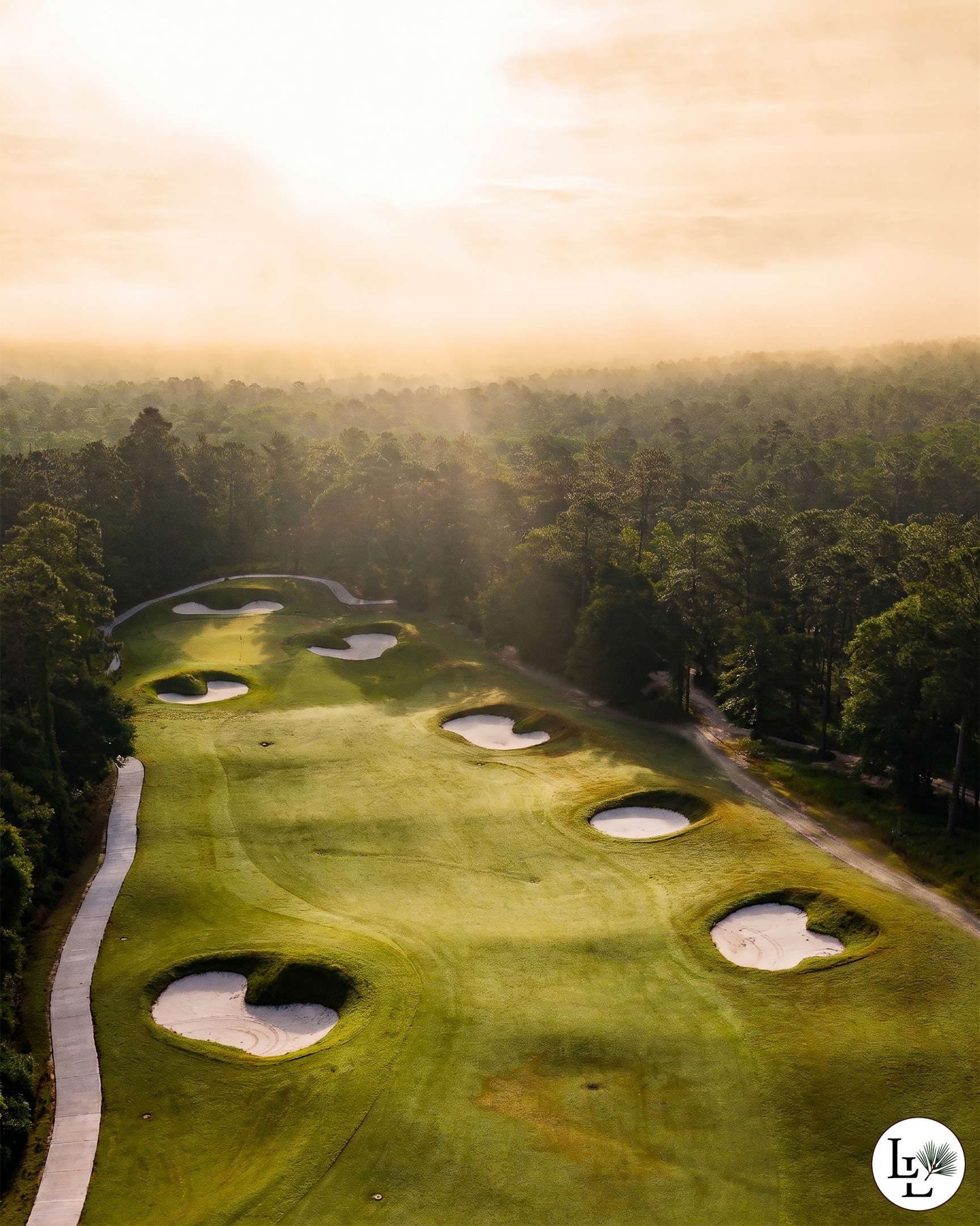 Bunkers scattered down a misty fairway at Longleaf